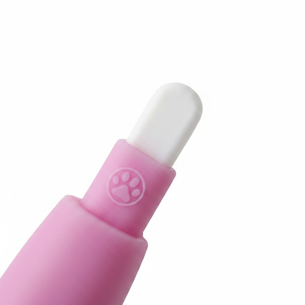 Close-up macro of blue silicone finger toothbrush showing soft bristles and paw print detail